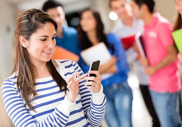 female student texting her cell