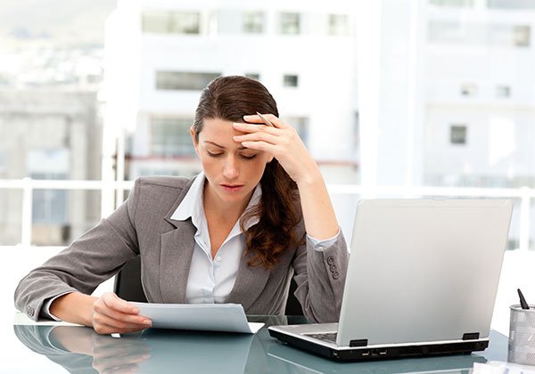 pensive businesswoman looking paper while